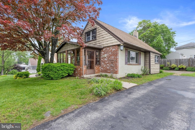 1011 Woodcliffe Ave, Media, PA 19063 - bungalow with brick siding, a chimney, a sunroom, and roof with shingles