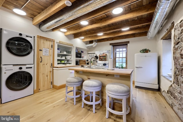 1700 N Texter Mountain Rd, Reinholds, PA 17569 - kitchen featuring freestanding refrigerator, stacked washer and clothes dryer, butcher block countertops, light wood finished floors, and wood ceiling with exposed beams