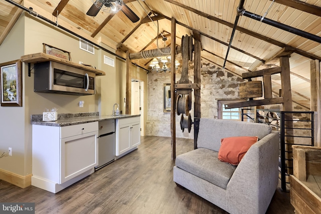 1700 N Texter Mountain Rd, Reinholds, PA 17569 - kitchen featuring wood ceiling with exposed beams, stainless steel microwave, wood finished floors, open floor plan, and white cabinetry
