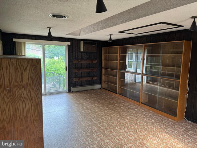 402 W Summit St, Mohnton, PA 19540 - spare room featuring a textured ceiling, a baseboard heating unit, wooden walls, tile patterned floors, and a wall unit AC