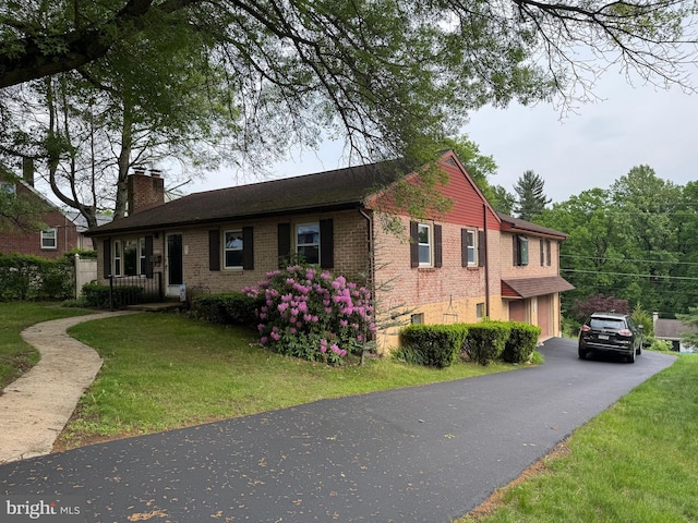 402 W Summit St, Mohnton, PA 19540 - single story home with a chimney, a front yard, asphalt driveway, brick siding, and an attached garage