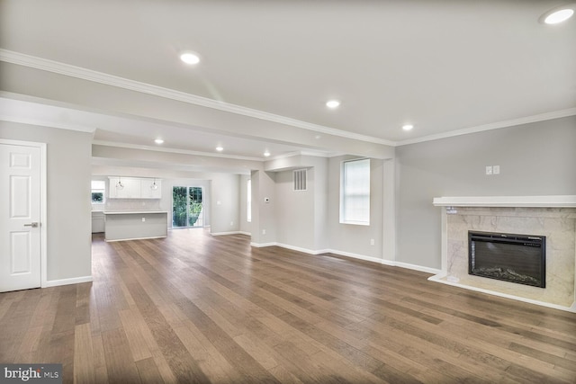 3604 White Ave, Baltimore, MD 21206 - unfurnished living room with dark wood-style floors, a high end fireplace, baseboards, crown molding, and recessed lighting