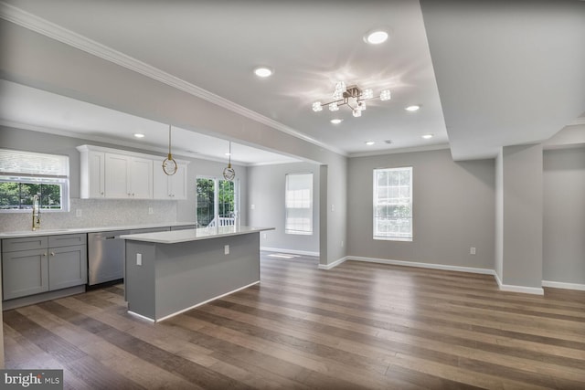 3604 White Ave, Baltimore, MD 21206 - kitchen with stainless steel dishwasher, a sink, crown molding, a kitchen island, and light countertops