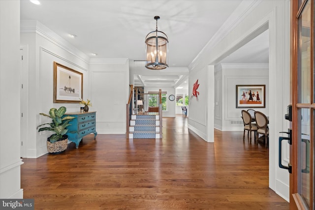 5 Raintree Rd, Chadds Ford, PA 19317 - foyer entrance with a decorative wall, a chandelier, wood finished floors, stairs, and ornamental molding