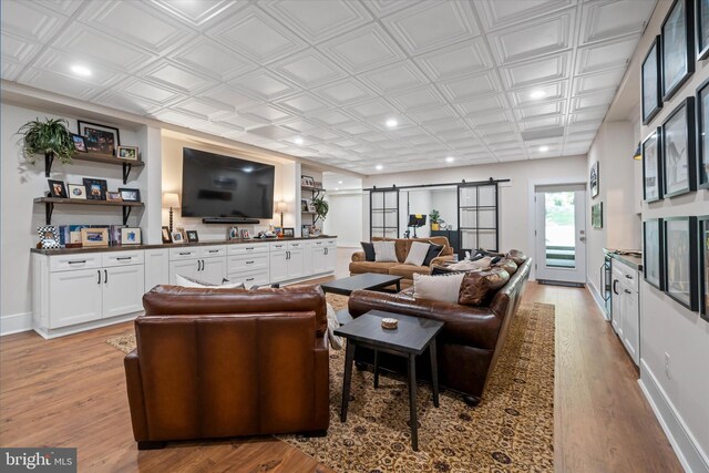 5 Raintree Rd, Chadds Ford, PA 19317 - living area featuring a barn door, light wood finished floors, recessed lighting, and an ornate ceiling