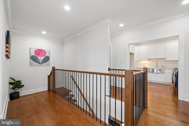 5 Raintree Rd, Chadds Ford, PA 19317 - hallway featuring an upstairs landing, light wood-style flooring, crown molding, recessed lighting, and a sink