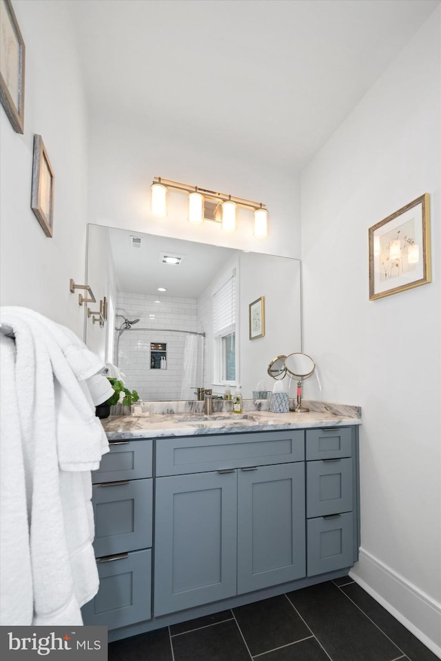 5 Raintree Rd, Chadds Ford, PA 19317 - full bathroom with double vanity, a tile shower, tile patterned floors, and baseboards