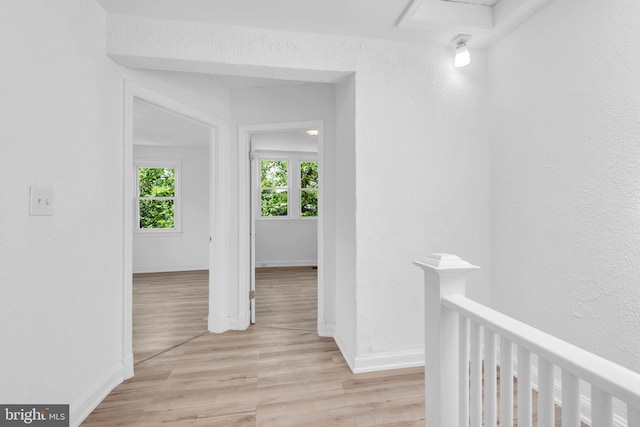 4428 Edson Pl NE, Washington, DC 20019 - hall with light wood-type flooring, a textured wall, an upstairs landing, and baseboards