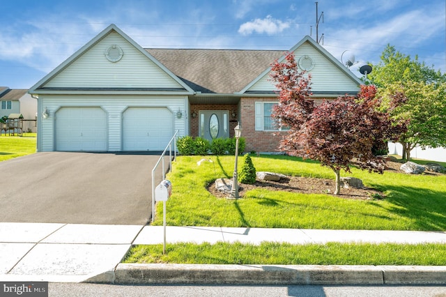 314 Valley Ct, Sinking Spring, PA 19608 - view of front of property featuring a garage, asphalt driveway, a front lawn, brick siding, and roof with shingles