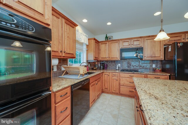 314 Valley Ct, Sinking Spring, PA 19608 - kitchen with black appliances, light stone counters, tasteful backsplash, light tile patterned floors, and decorative light fixtures