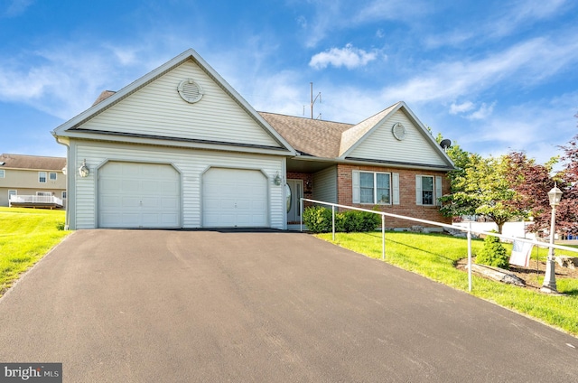 314 Valley Ct, Sinking Spring, PA 19608 - view of front of property with driveway, an attached garage, brick siding, and a front lawn