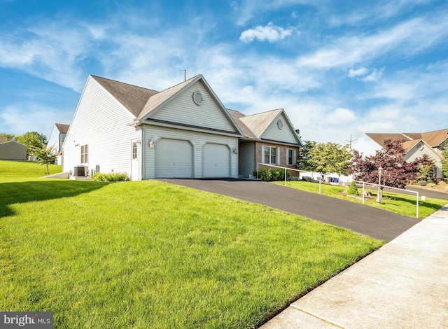 314 Valley Ct, Sinking Spring, PA 19608 - view of front of house with a garage, asphalt driveway, and a front lawn