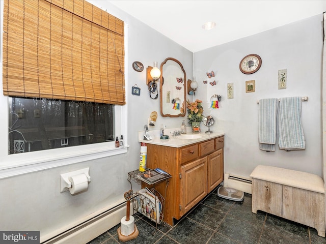 bathroom featuring a baseboard heating unit and vanity