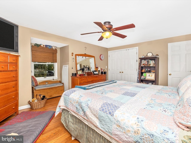 bedroom with light wood-style floors, a closet, and a ceiling fan