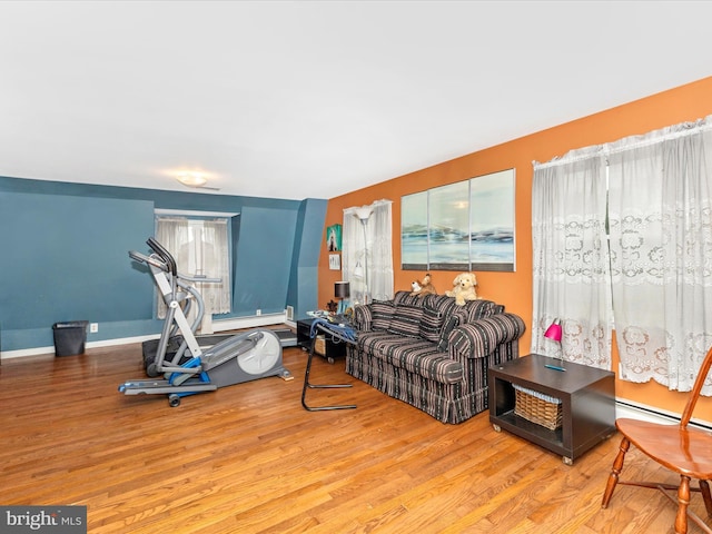 living area featuring wood finished floors and a baseboard radiator