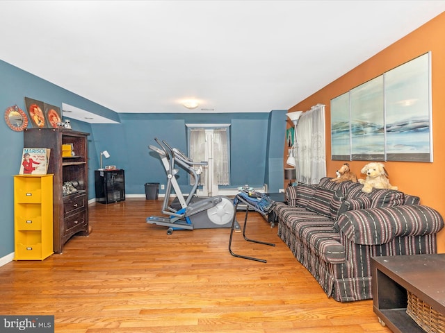 living area with wood finished floors and baseboards