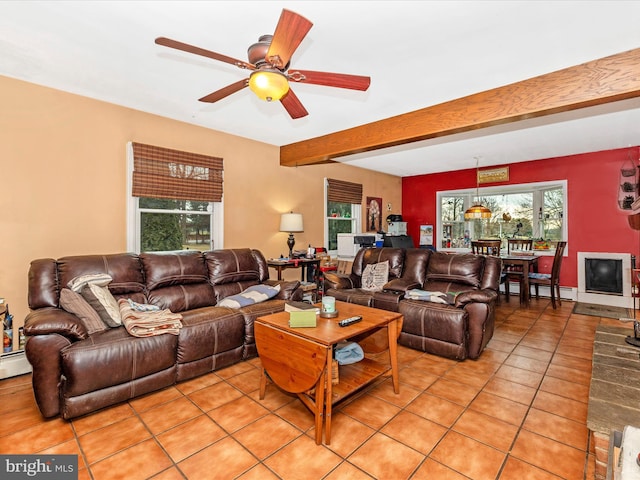 living room featuring light tile patterned flooring, beam ceiling, a ceiling fan, and a baseboard radiator