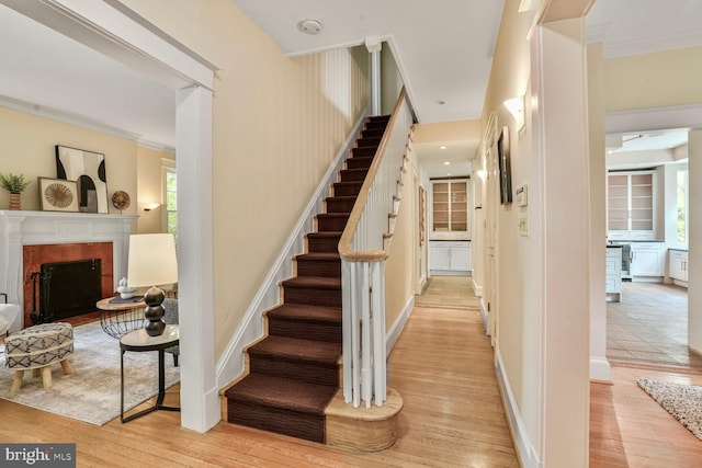 3707 Thornapple St, Chevy Chase, MD 20815 - stairs with hardwood / wood-style floors, a fireplace, and ornamental molding