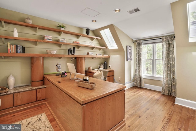 3707 Thornapple St, Chevy Chase, MD 20815 - home office with baseboards, light wood-style flooring, vaulted ceiling, a skylight, and recessed lighting