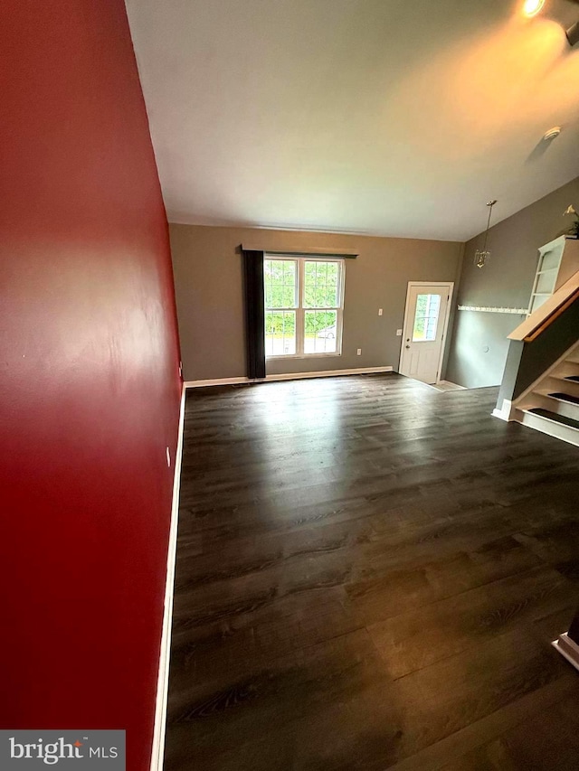 821 W Potomac St, Brunswick, MD 21716 - unfurnished living room with wood finished floors, baseboards, and stairway