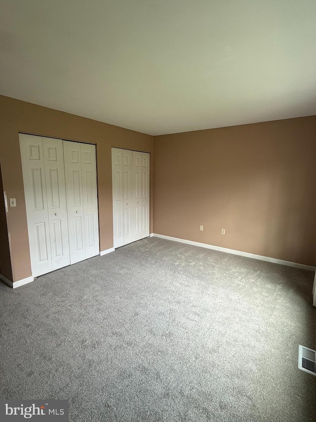 821 W Potomac St, Brunswick, MD 21716 - unfurnished bedroom with multiple closets, baseboards, and carpet floors