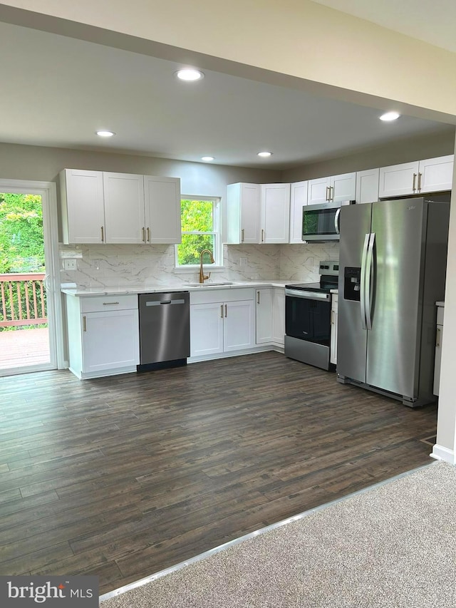 14400 Northumberland Hwy, Heathsville, VA 22473 - kitchen featuring appliances with stainless steel finishes, a sink, white cabinets, backsplash, and recessed lighting