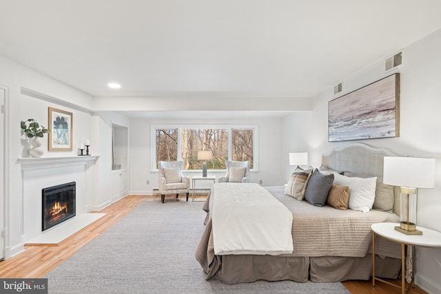 710 Belgrove Rd, Mclean, VA 22101 - bedroom featuring wood finished floors, a glass covered fireplace, recessed lighting, and baseboards