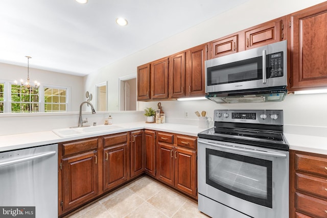 16909 Batchellors Forest Rd, Silver Spring, MD 20906 - kitchen featuring stainless steel appliances, a sink, a chandelier, light countertops, and recessed lighting