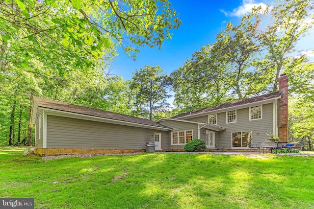 16909 Batchellors Forest Rd, Silver Spring, MD 20906 - rear view of property featuring a yard, a chimney, and a patio