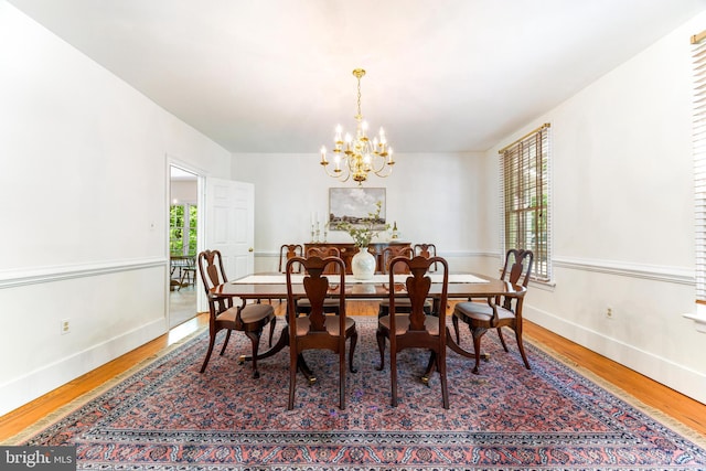 16909 Batchellors Forest Rd, Silver Spring, MD 20906 - dining area featuring wood finished floors, a chandelier, and baseboards