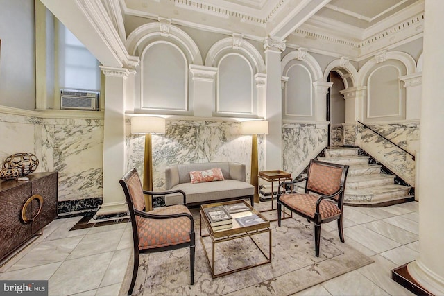 building lobby with ornamental molding, wainscoting, and a towering ceiling