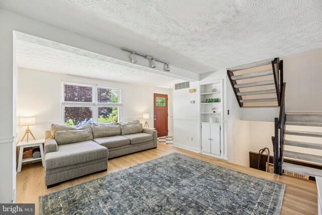 2908 Ruskin Ct, Abingdon, MD 21009 - living room with stairs, wood finished floors, a textured ceiling, and rail lighting