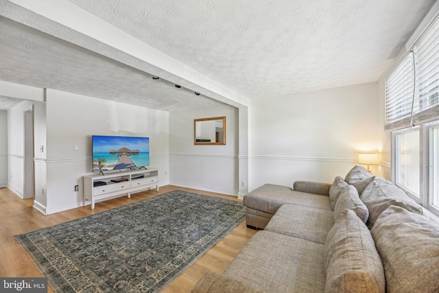 2908 Ruskin Ct, Abingdon, MD 21009 - living area with a textured ceiling, wood finished floors, and baseboards