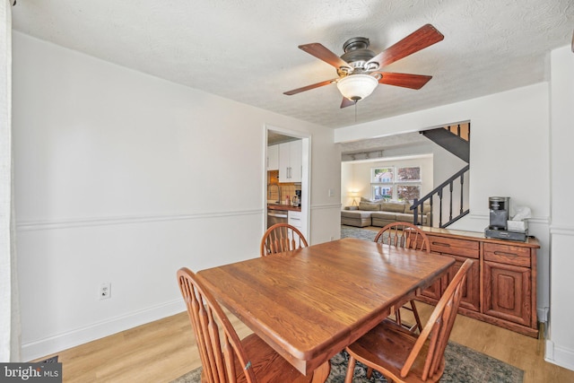 2908 Ruskin Ct, Abingdon, MD 21009 - dining area with stairway, light wood-style floors, ceiling fan, and baseboards