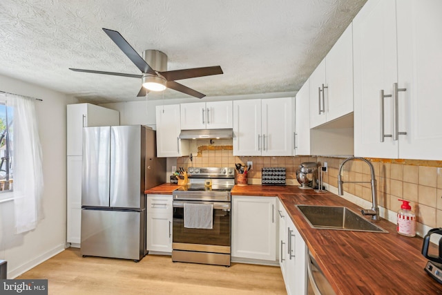 2908 Ruskin Ct, Abingdon, MD 21009 - kitchen featuring butcher block counters, appliances with stainless steel finishes, a sink, under cabinet range hood, and ceiling fan
