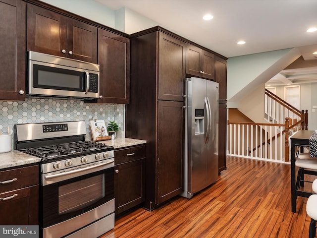 628 E Fort Ave, Baltimore, MD 21230 - kitchen featuring stainless steel appliances, wood finished floors, dark brown cabinets, decorative backsplash, and recessed lighting