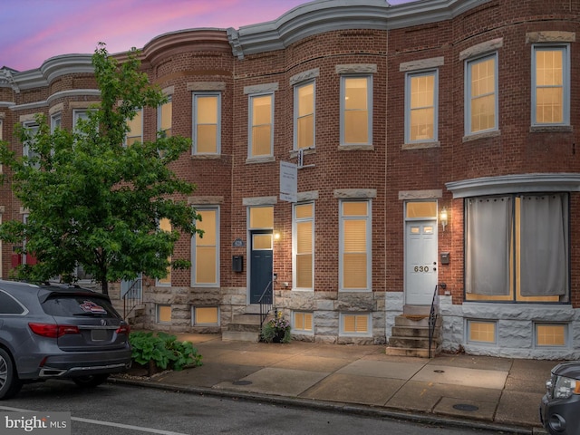 628 E Fort Ave, Baltimore, MD 21230 - view of property featuring entry steps, brick siding, and stone siding