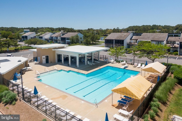 17 Robins Ln, Rehoboth Beach, DE 19971 - community pool featuring a residential view and a patio