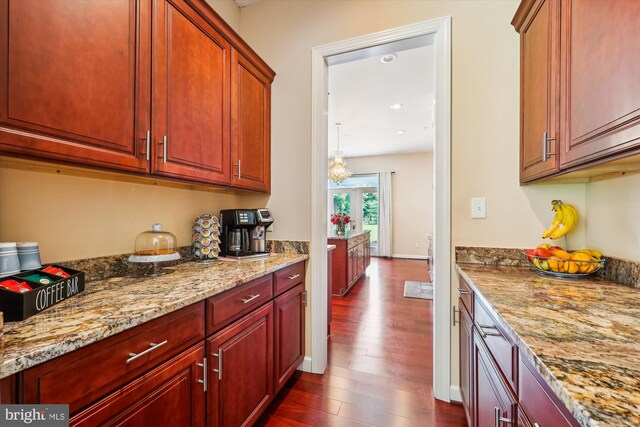 15613 Ancient Oak, North Potomac, MD 20878 - kitchen featuring dark wood-style flooring, light stone countertops, reddish brown cabinets, and recessed lighting