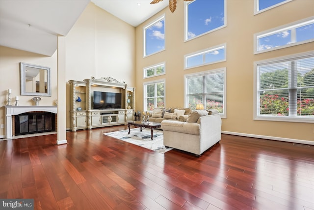 15613 Ancient Oak, North Potomac, MD 20878 - living room featuring a high ceiling, a glass covered fireplace, wood finished floors, and ceiling fan