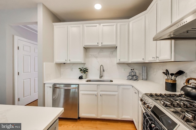 9093 Acheson Ct, Lorton, VA 22079 - kitchen with stainless steel appliances, a sink, under cabinet range hood, white cabinets, and light countertops
