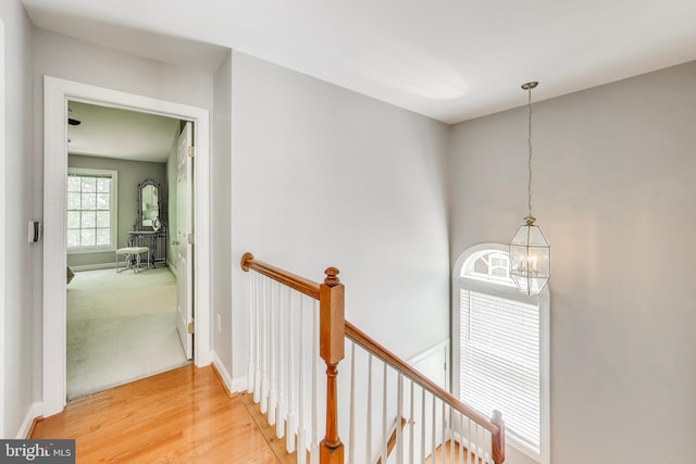 9093 Acheson Ct, Lorton, VA 22079 - hall featuring an upstairs landing, a chandelier, light wood-type flooring, and baseboards