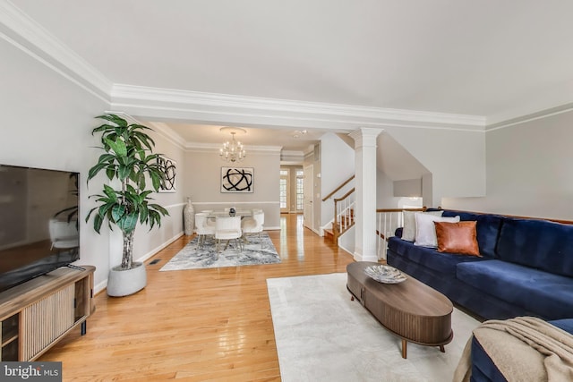 9093 Acheson Ct, Lorton, VA 22079 - living room with a chandelier, light wood-style flooring, ornamental molding, stairs, and baseboards