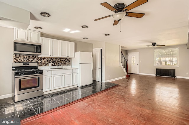4904 Pembridge Ave, Baltimore, MD 21215 - kitchen featuring stainless steel appliances, radiator, ceiling fan, and tasteful backsplash