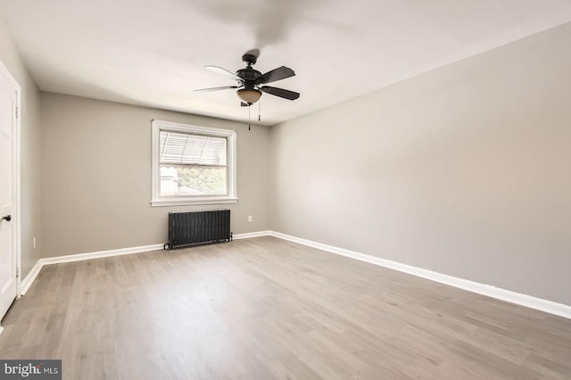 4904 Pembridge Ave, Baltimore, MD 21215 - empty room with radiator, wood finished floors, ceiling fan, and baseboards