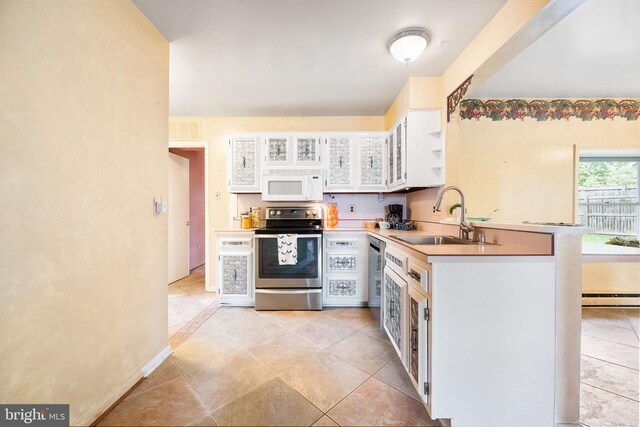 1213 Terrylynn Ct, Herndon, VA 20170 - kitchen featuring stainless steel appliances, a sink, white cabinetry, light countertops, and glass insert cabinets