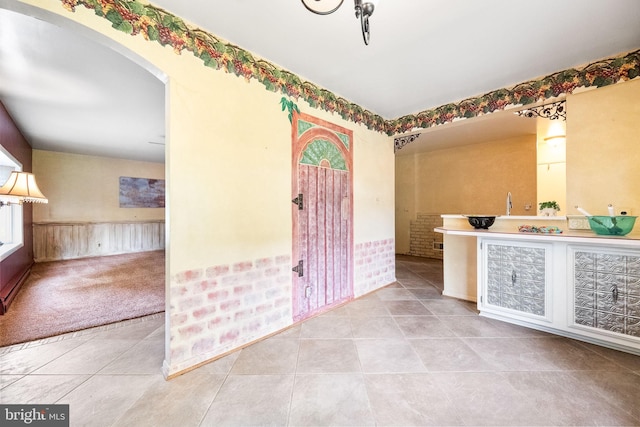 1213 Terrylynn Ct, Herndon, VA 20170 - carpeted entrance foyer with a wainscoted wall, tile patterned floors, and arched walkways