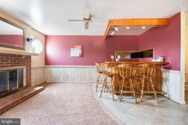 1213 Terrylynn Ct, Herndon, VA 20170 - indoor dry bar with wainscoting, a ceiling fan, a brick fireplace, and tile patterned flooring