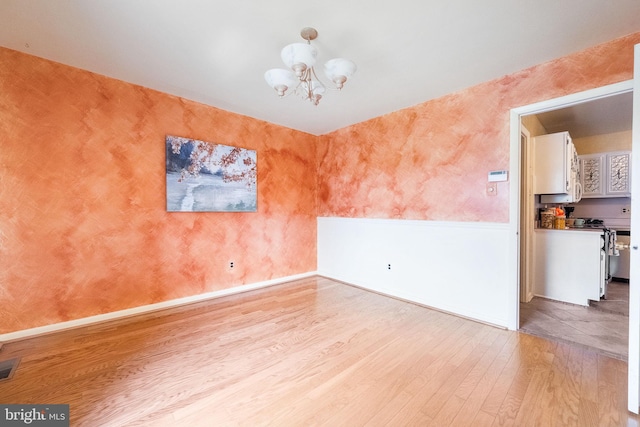 1213 Terrylynn Ct, Herndon, VA 20170 - unfurnished room with light wood finished floors, a chandelier, wallpapered walls, and baseboards