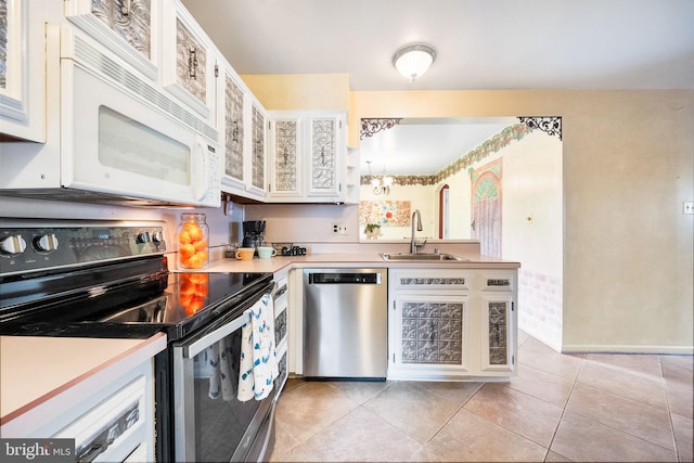 1213 Terrylynn Ct, Herndon, VA 20170 - kitchen with appliances with stainless steel finishes, a sink, a peninsula, light countertops, and light tile patterned floors